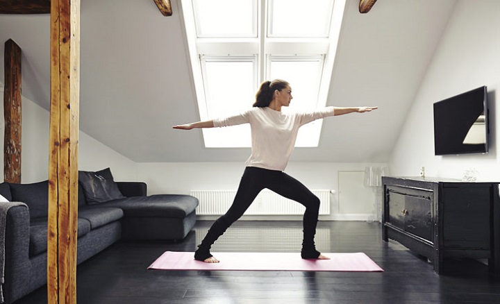 woman-white-sweatshirt-black-yoga-pants-practicing-home-05152015.jpg